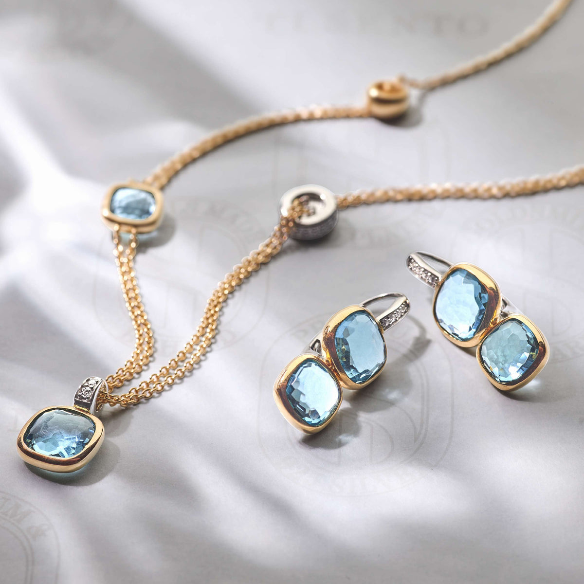 Gold Vermeil layered necklace with blue cushion stones, styled