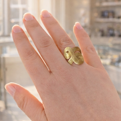 Hand wearing an H.Stern Celtic Dunes 18ct gold ring within Urban Armour Jewellery Boutique, Burnham Market