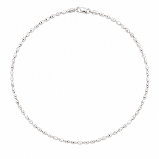 A silver beaded chain necklace arranged in a circle on a plain white background.