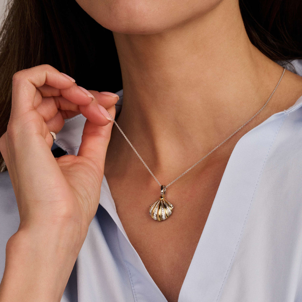 Gold Vermeil and Sterling Silver Two Tone shell pendant with cubic zirconia, worn
