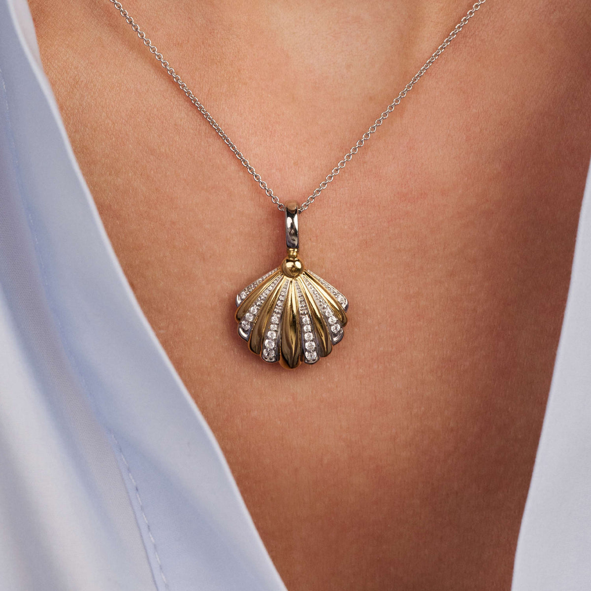 Gold Vermeil and Sterling Silver Two Tone shell pendant with cubic zirconia, worn