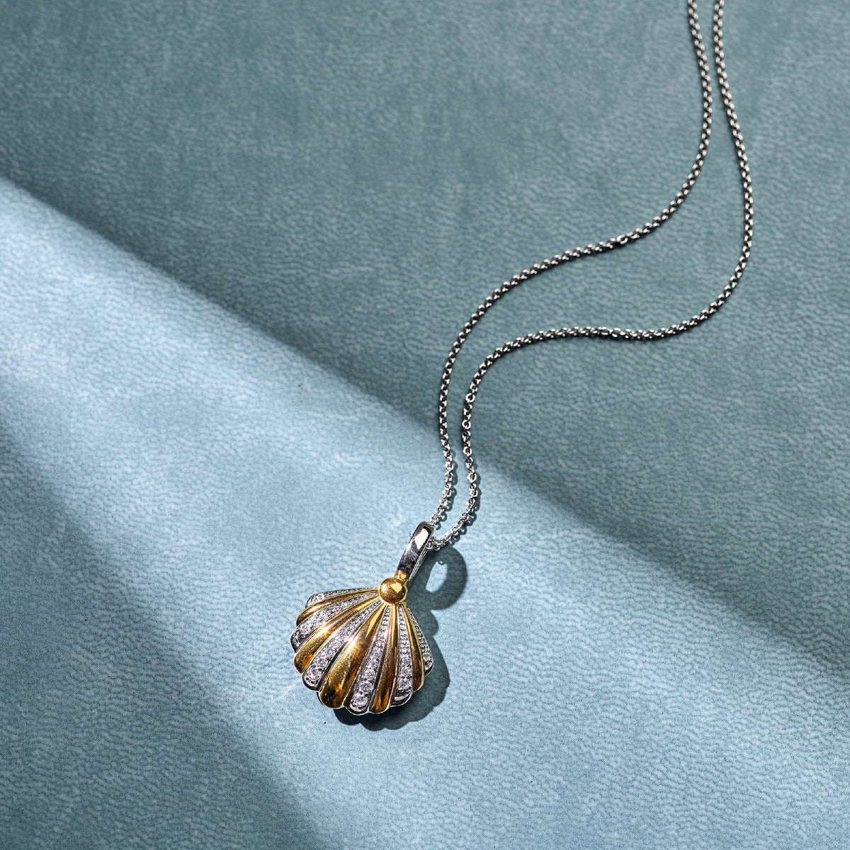 Gold Vermeil and Sterling Silver Two Tone shell pendant with cubic zirconia, styled