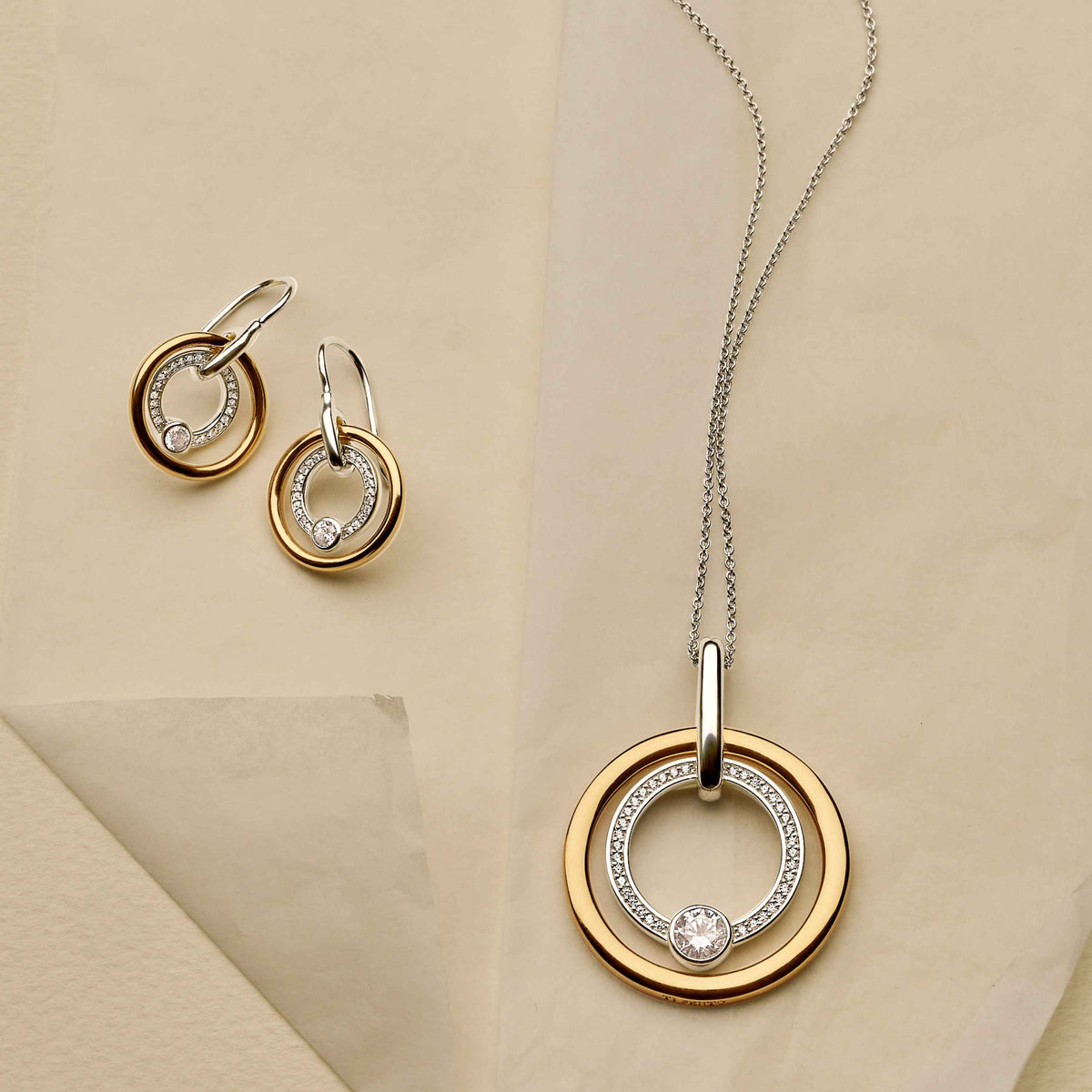 Gold Vermeil and Sterling Silver Two Tone circle drop earrings with cubic zirconia, styled
