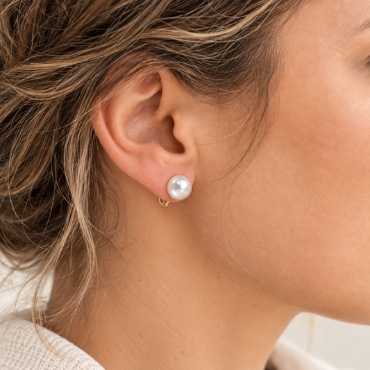 9ct Gold Pearl Clip-On Earrings, pearl sitting against the earlobe with fine gold fitting underneath