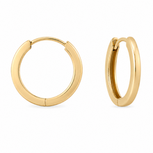 Load image into Gallery viewer, A pair of polished gold huggie hoop earrings shown on a clean white background, with one earring facing forward and the other in profile.
