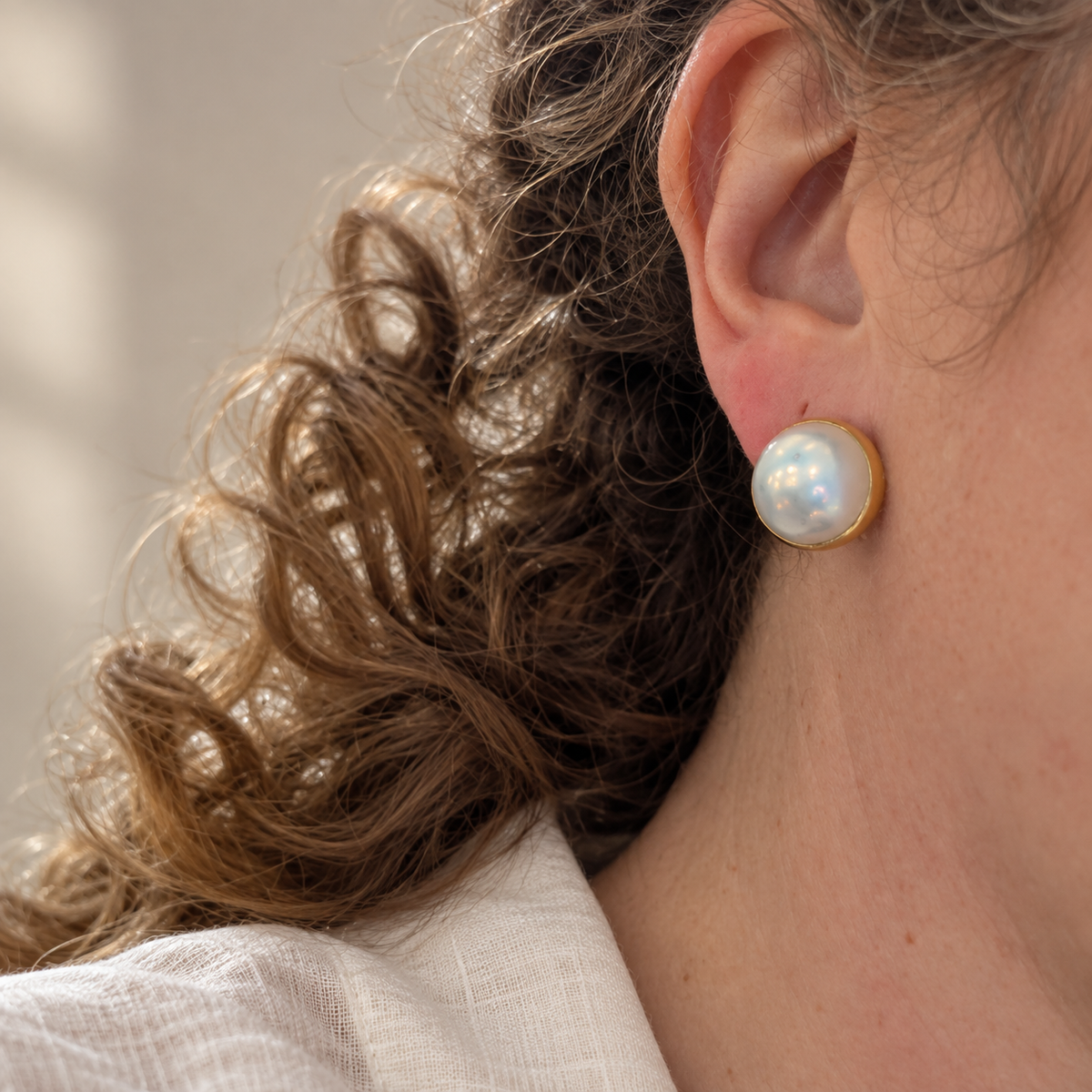 18ct Gold Mabé Pearl Clip-On Earring worn on the ear