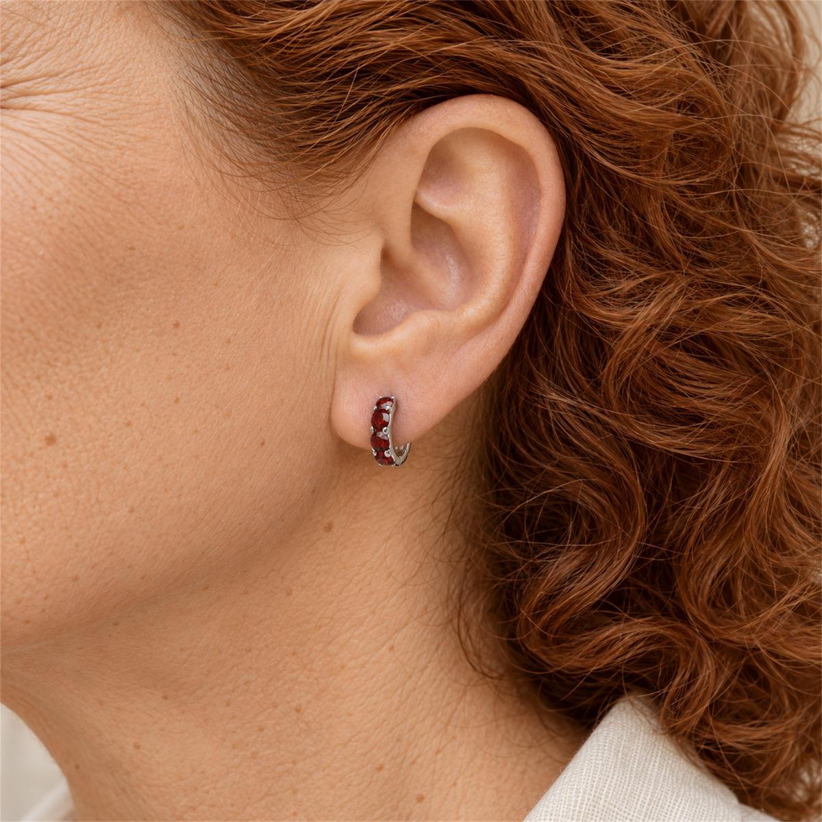 Sterling Silver Ruby Colour Cubic Zirconia Huggie Earrings worn by the Urban Armour model