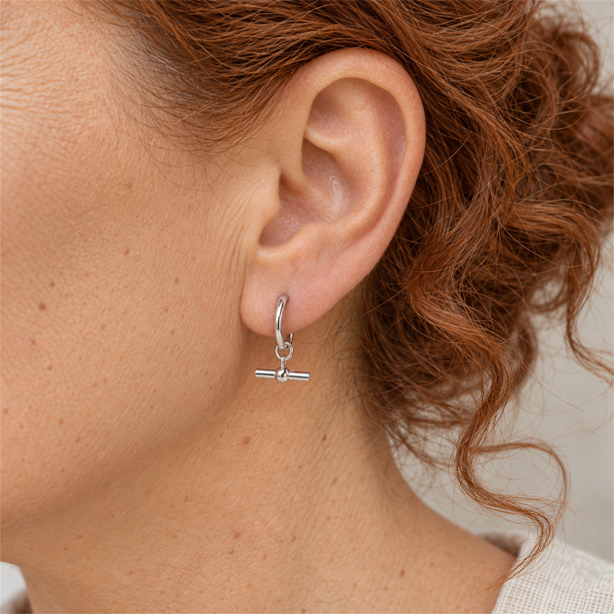 Sterling Silver Mini T-Bar Hoop Earrings worn by the Urban Armour model