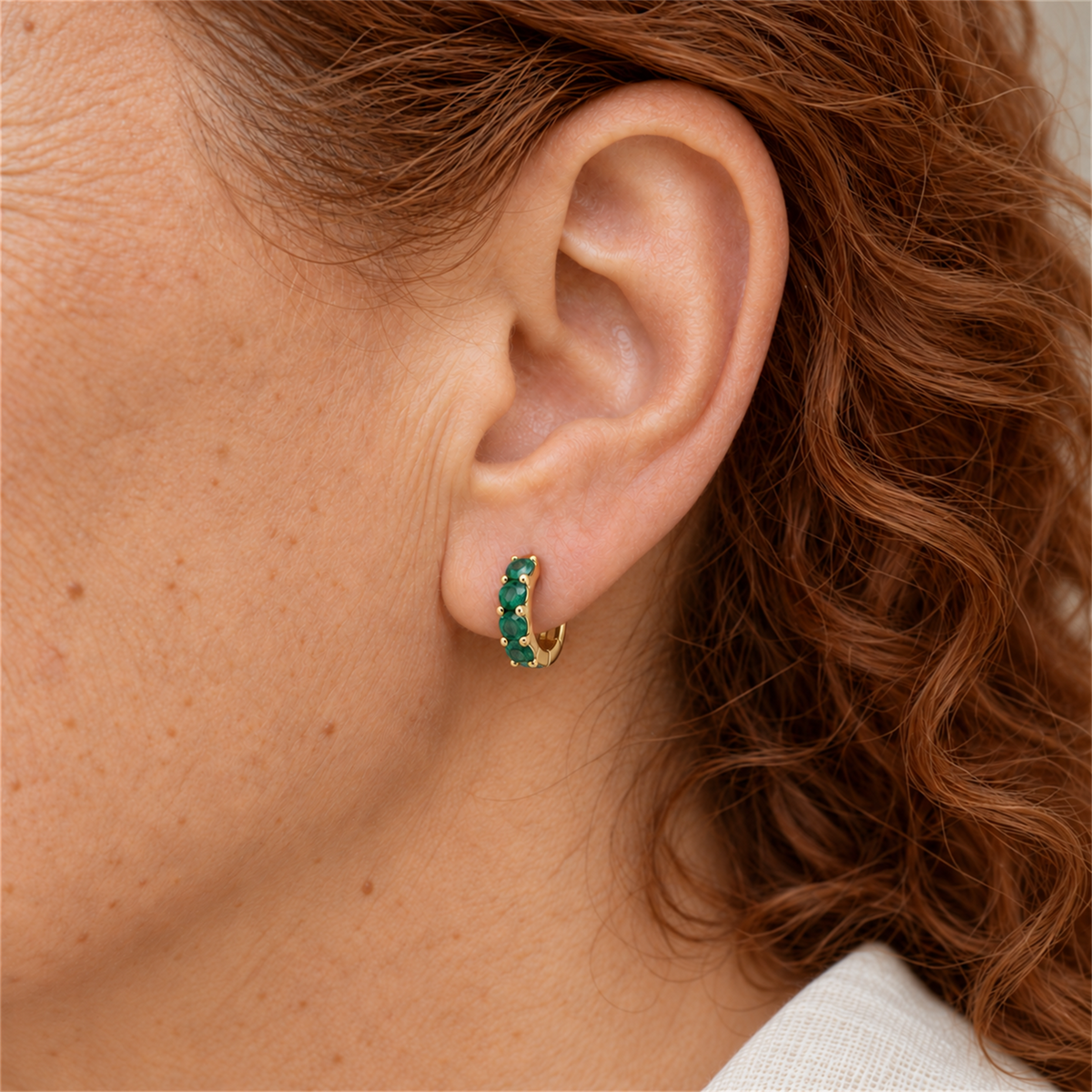 Gold Vermeil emerald colour cubic zirconia huggie with four stones worn by Urban Armour model