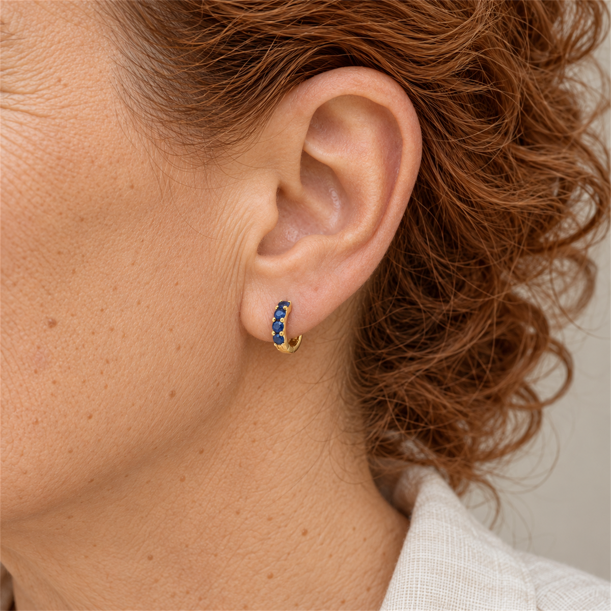 Gold Vermeil Sapphire Colour Cubic Zirconia Huggie Earrings worn by the Urban Armour model