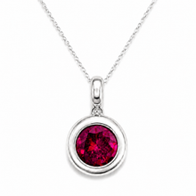 Load image into Gallery viewer, A silver pendant necklace featuring a round, deep red gemstone surrounded by a double-ring silver bezel, suspended from a delicate silver chain on a white background.
